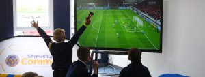 Child celebrates scoring goal on FIFA playstation